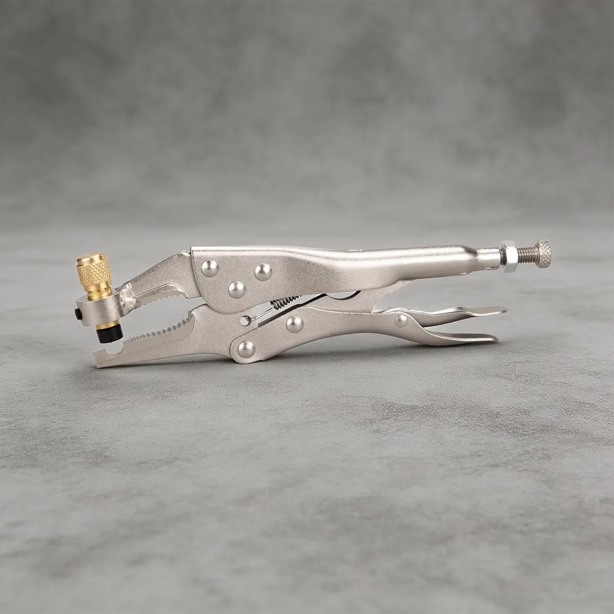 The DOMINOX refrigerant recovery plier on a grey surface