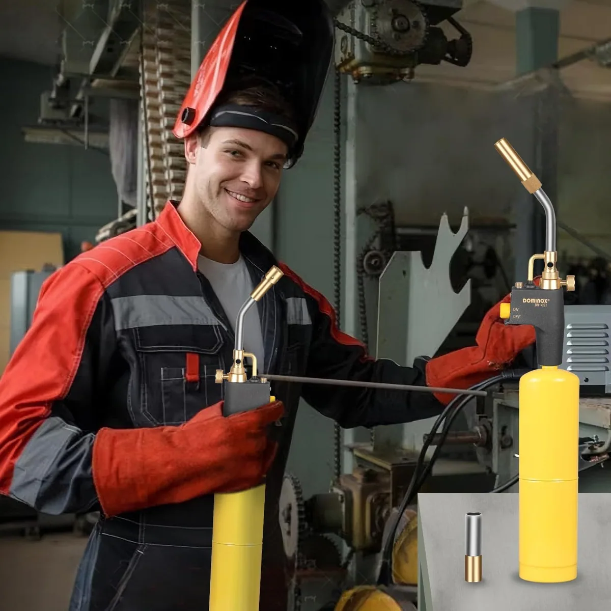 A welder in a red jacket holding a lit DOMINOX torch on a yellow cylinder